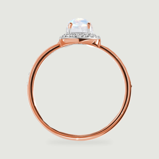 A side view of the rose gold ring shows the pale moonstone, supporting prongs, and polished band.