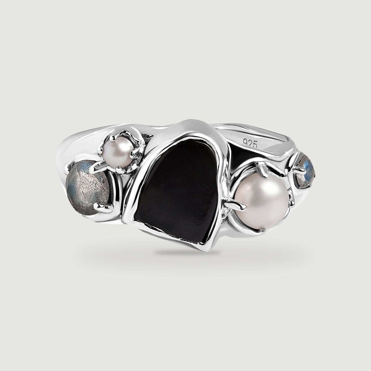 A sterling silver ring with a black center stone, two white pearls, and two blue-gray side stones on a light gray background.