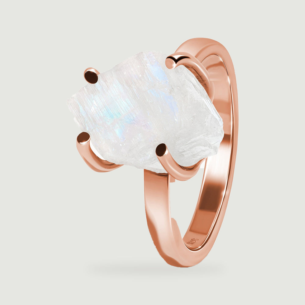An upright rose gold ring shows the raised rough moonstone setting and the curved band.