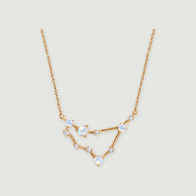 A yellow gold necklace with an angular open pendant, four round iridescent stones, and small clear accents.