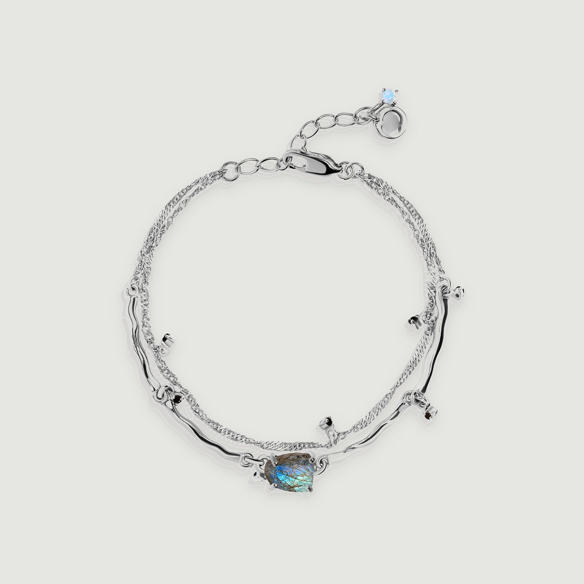 A silver bracelet forms an oval with a rough blue-flashing centre stone, curved links and an adjustable clasp.