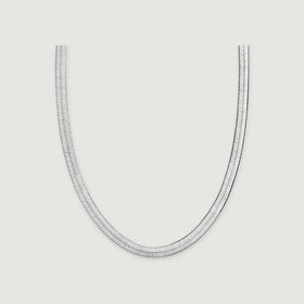 A white rhodium plated herringbone chain forms a broad U shape on a light gray surface.