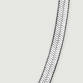 The rising right side of the flat chain shows its slim edge and reflective link pattern.
