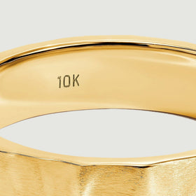 The inside of the yellow gold band shows a small 10K stamp below a polished rim.
