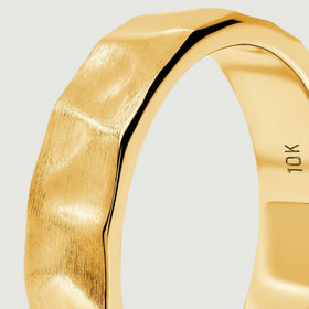 A close side view shows the yellow gold ring with a brushed face beside a narrow polished edge.