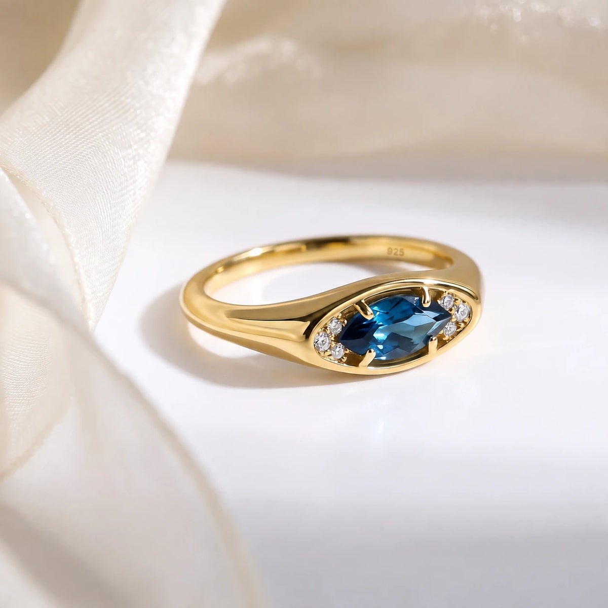 Clear Horizon blue topaz eye ring, gold flatlay