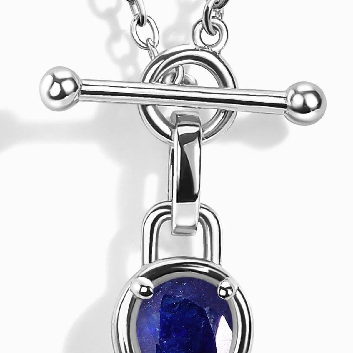 A polished silver-tone bar crosses a circular clasp above the pendant connector.