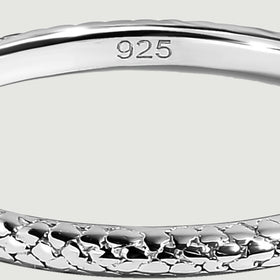 The smooth inner surface of a silver ring bears a 925 purity stamp above the textured front edge.