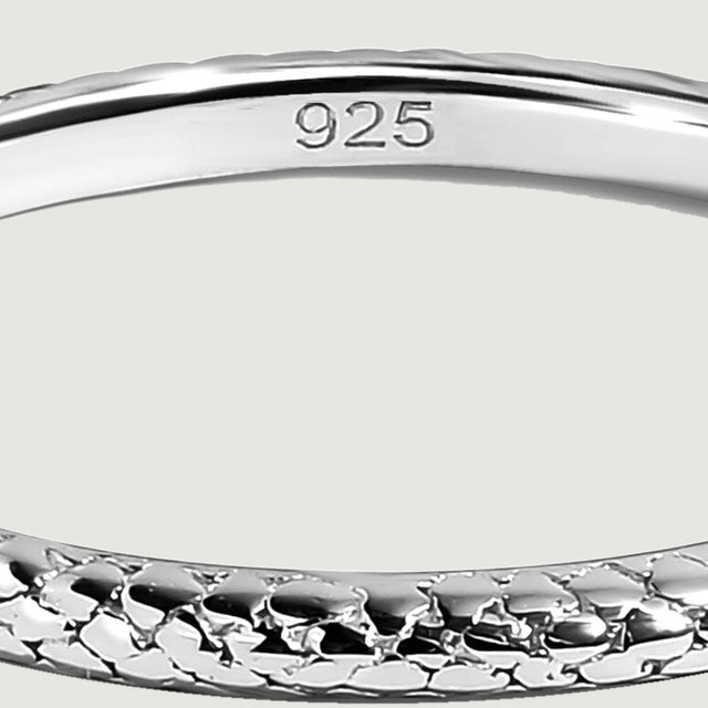 The smooth inner surface of a silver ring bears a 925 purity stamp above the textured front edge.