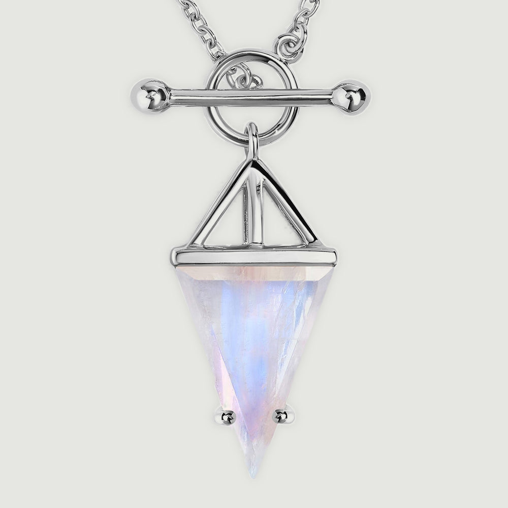 A close view shows the silver circular clasp, rounded horizontal bar, and blue sheen across the triangular moonstone.