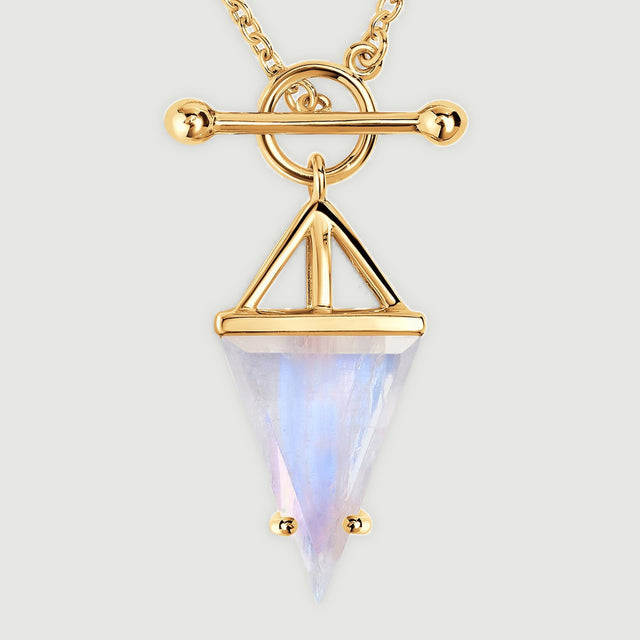 The yellow gold vermeil pendant has an open triangular mount above a pale moonstone with a soft blue reflection.