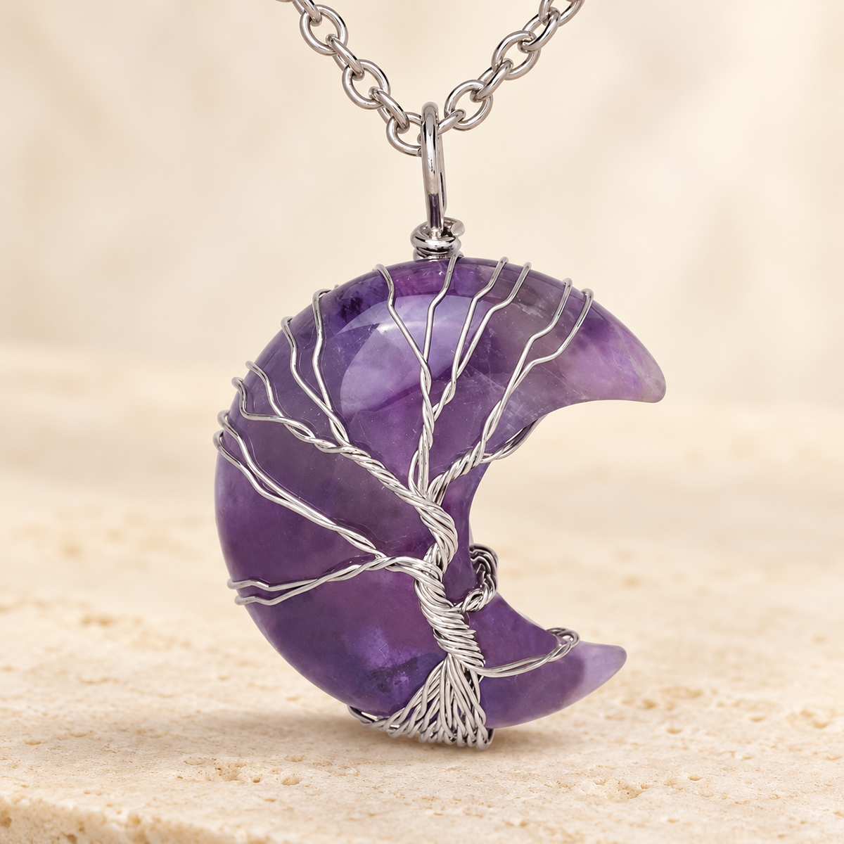 Purple crescent pendant with a wire-wrapped tree; AI-edited draft reference.