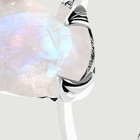 A close angled view reveals the moonstone edge and individual clear stones set into the silver shoulder.