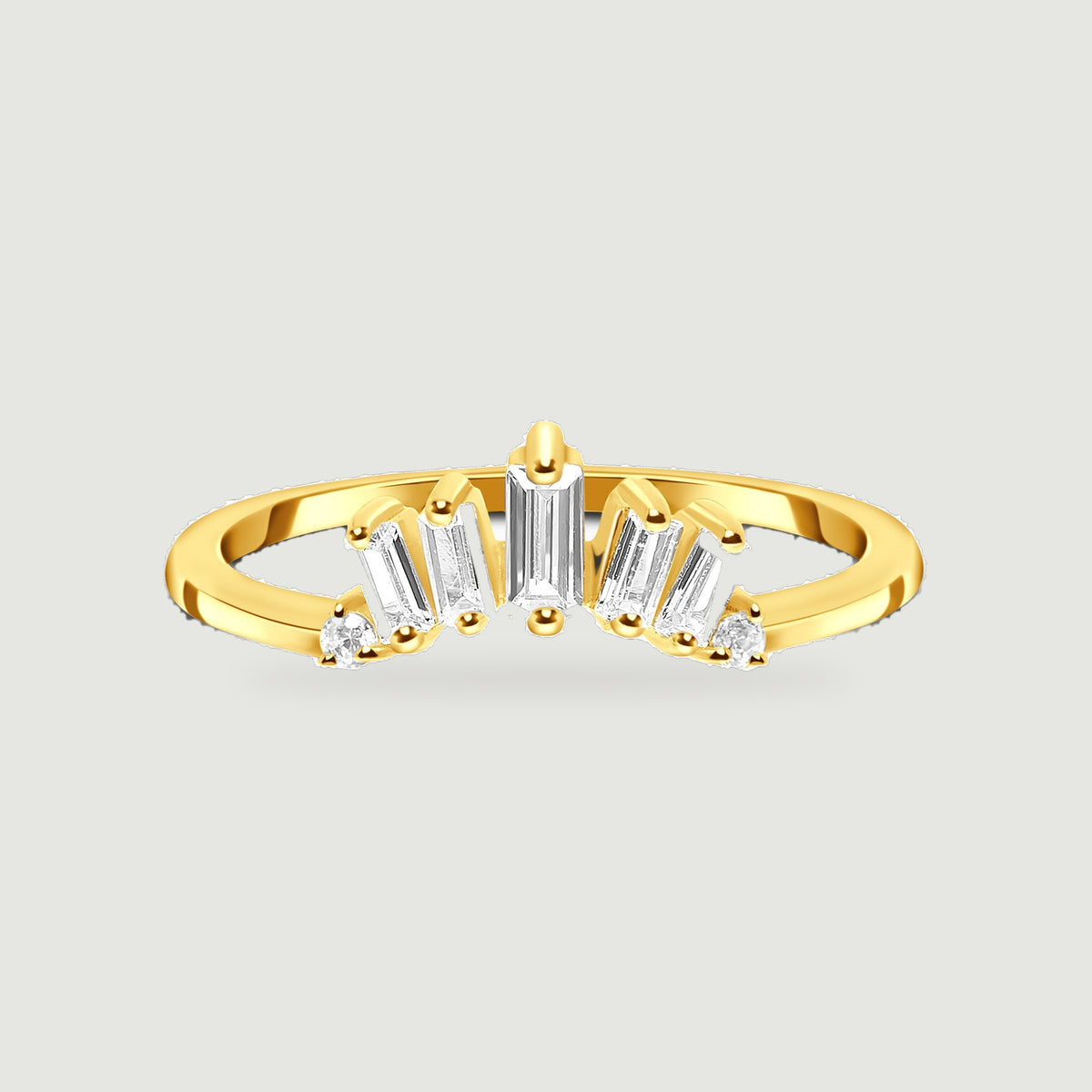 A yellow gold vermeil ring displays five graduated baguette stones and two round stones on a light gray background.