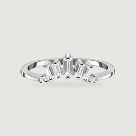A sterling silver ring is centered on a pale gray surface with its polished band and clear stone setting visible.