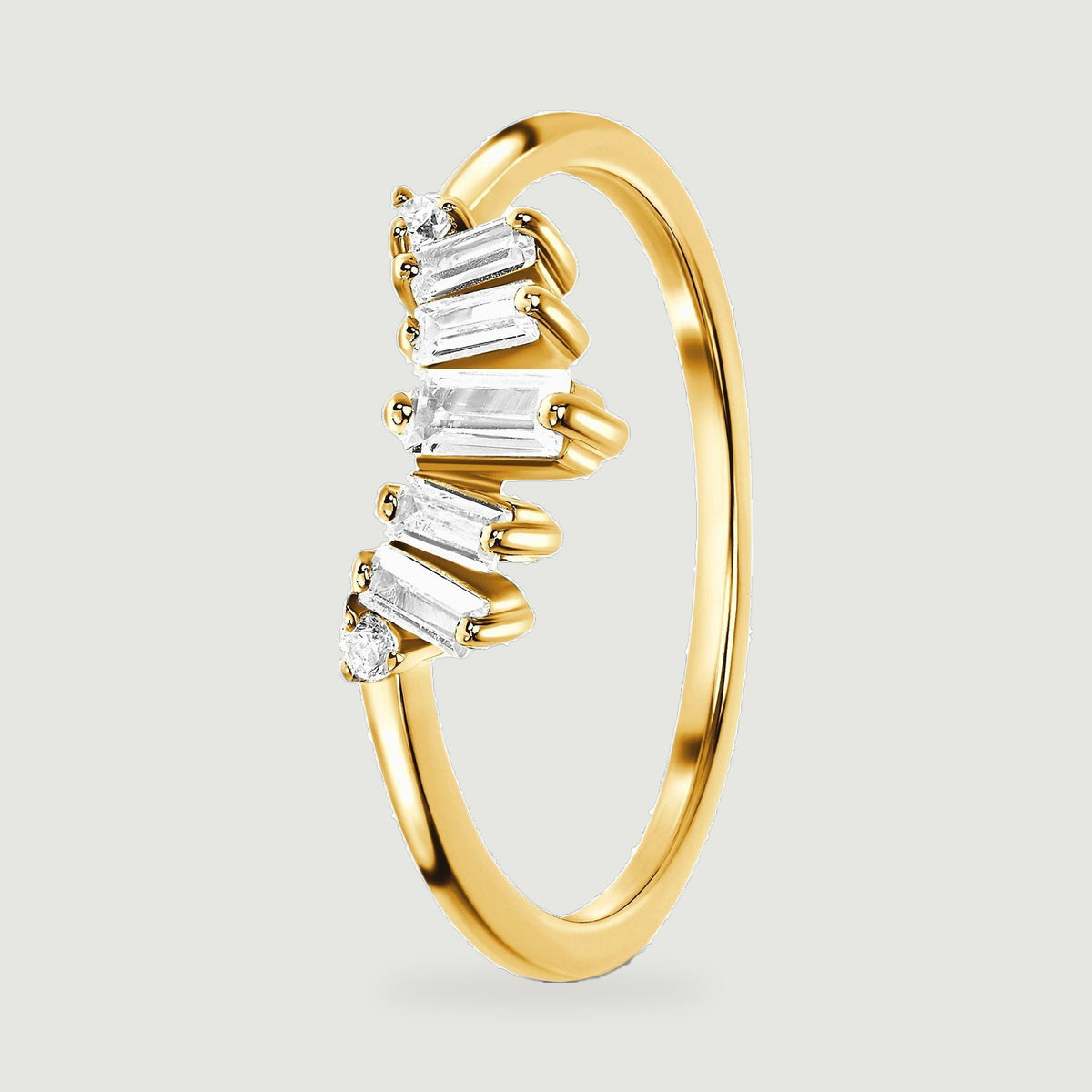 An upright yellow gold vermeil band shows its slim shank and raised clear stone setting from the side.