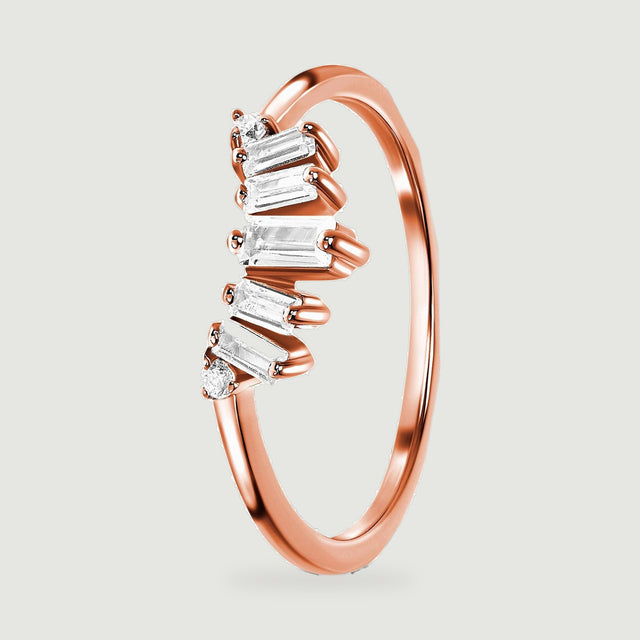 A rose gold vermeil ring is shown at an angle with the prongs and side faces of the baguette stones visible.