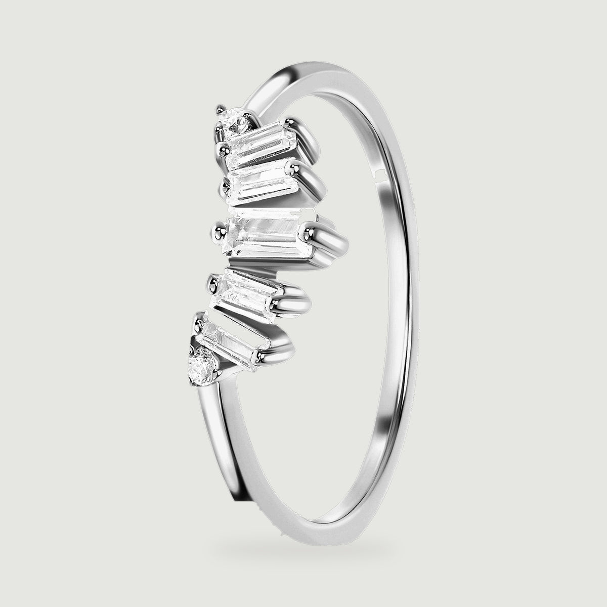 An angled sterling silver band reveals the open space beneath its clear stones and the smooth inner curve.