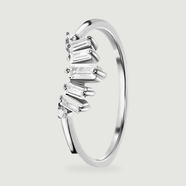 An angled sterling silver band reveals the open space beneath its clear stones and the smooth inner curve.
