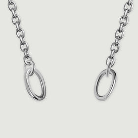 Two polished oval end rings and the adjacent silver chain links are shown in close detail.