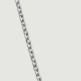 A diagonal length of fine silver chain reveals alternating open oval links on a clean gray surface.