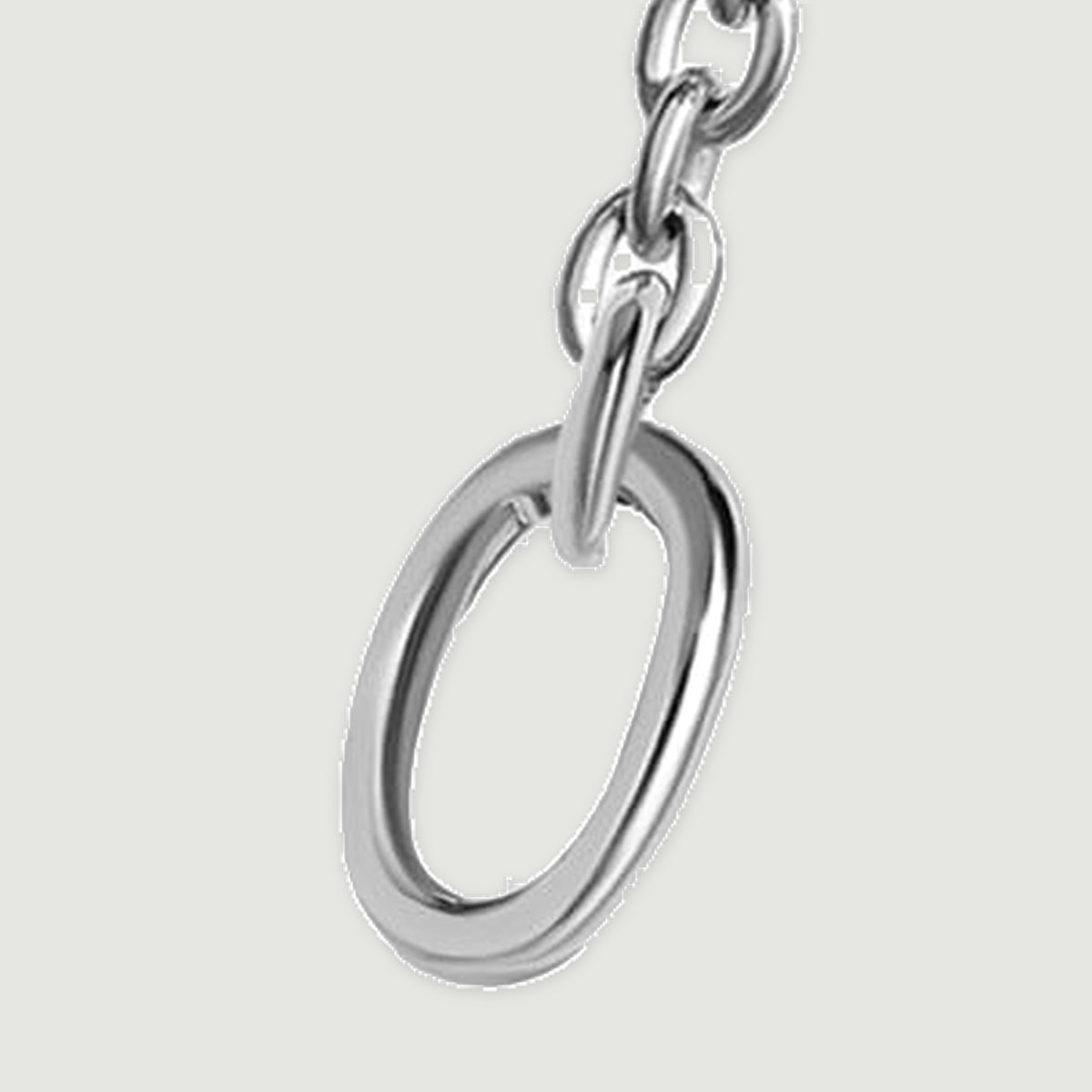 The right oval end ring is shown close up with polished silver edges and a short section of chain.