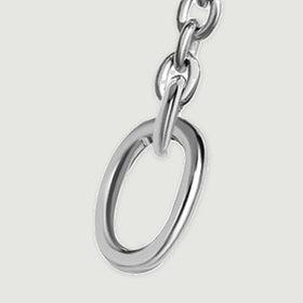The right oval end ring is shown close up with polished silver edges and a short section of chain.
