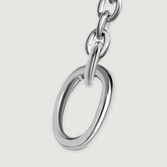 The right oval end ring is shown close up with polished silver edges and a short section of chain.