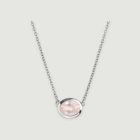 A pale pink oval rose quartz pendant sits in a polished white metal bezel on a fine link chain against a light gray background.