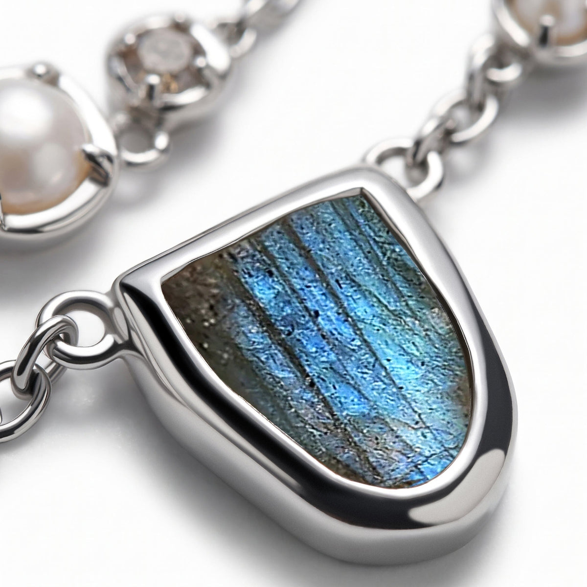 A close view shows blue striations in the labradorite and the rounded silver-tone rim around it.