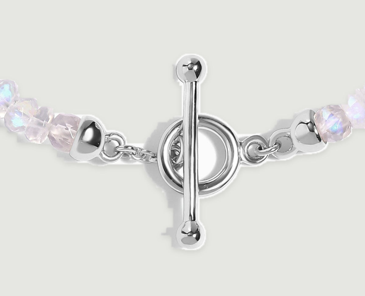 A close view shows the silver bar, circular clasp, short chain links and adjacent moonstone beads.