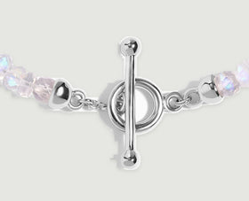 A close view shows the silver bar, circular clasp, short chain links and adjacent moonstone beads.