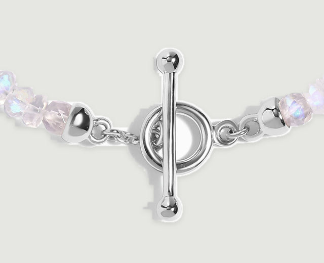 A close view shows the silver bar, circular clasp, short chain links and adjacent moonstone beads.