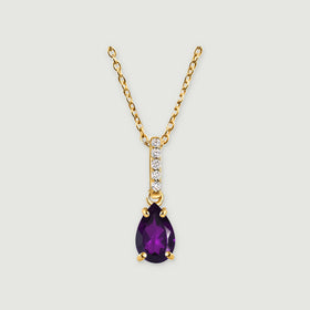 A yellow gold vermeil chain leads to a five-stone bail and a purple pear-shaped pendant centered on a light grey surface.