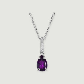 A sterling silver necklace displays a purple faceted pear pendant and five clear stones above an open connecting ring.