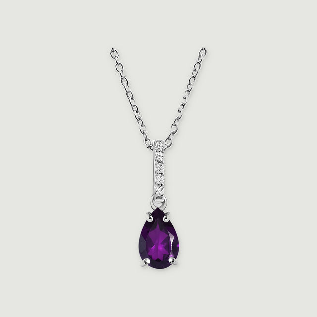 A sterling silver necklace displays a purple faceted pear pendant and five clear stones above an open connecting ring.