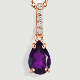 A close view shows rose gold prongs around a purple pear-shaped amethyst below five round clear stones.