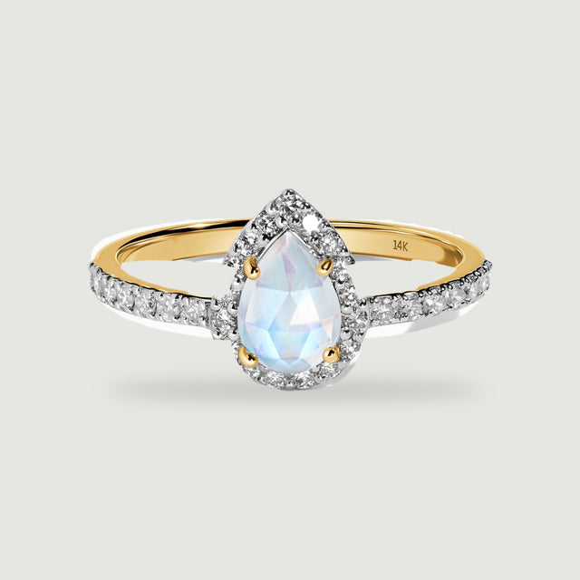 A yellow gold band curves behind a pear-cut moonstone surrounded by small clear diamonds.