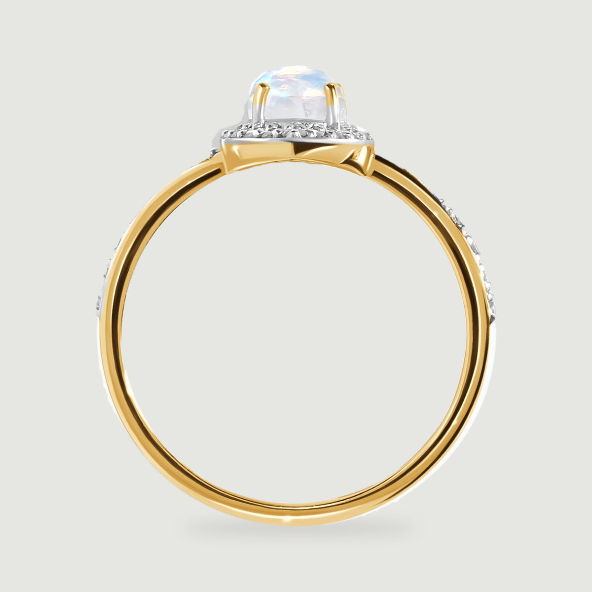A side view of the yellow gold ring reveals the elevated moonstone setting above its rounded band.