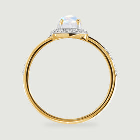 A side view of the yellow gold ring reveals the elevated moonstone setting above its rounded band.