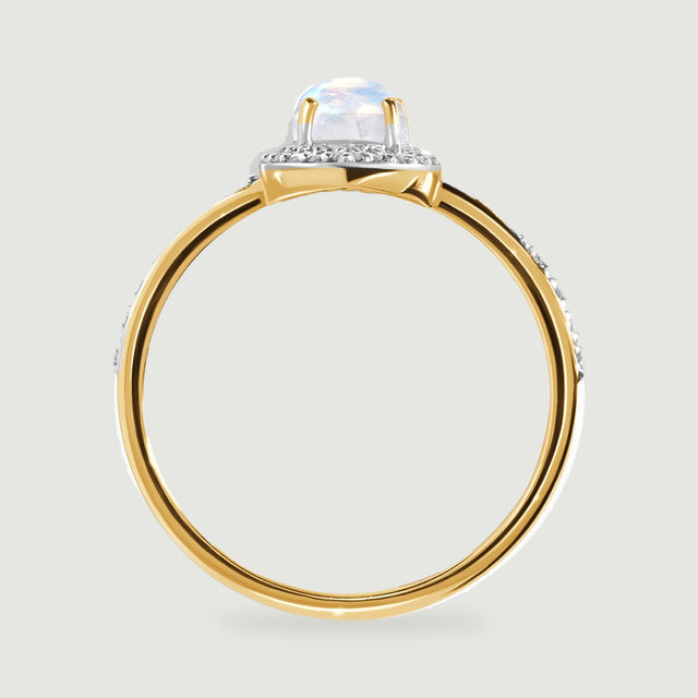 A side view of the yellow gold ring reveals the elevated moonstone setting above its rounded band.