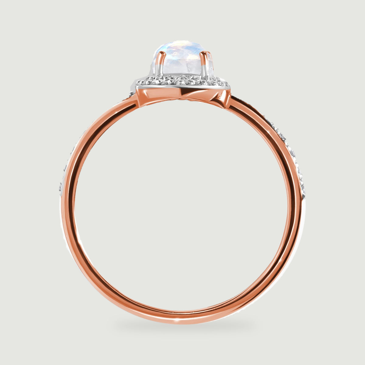 The rose gold band and prongs are visible beneath the pale iridescent moonstone in profile.