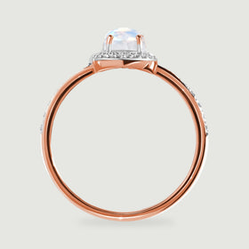 The rose gold band and prongs are visible beneath the pale iridescent moonstone in profile.