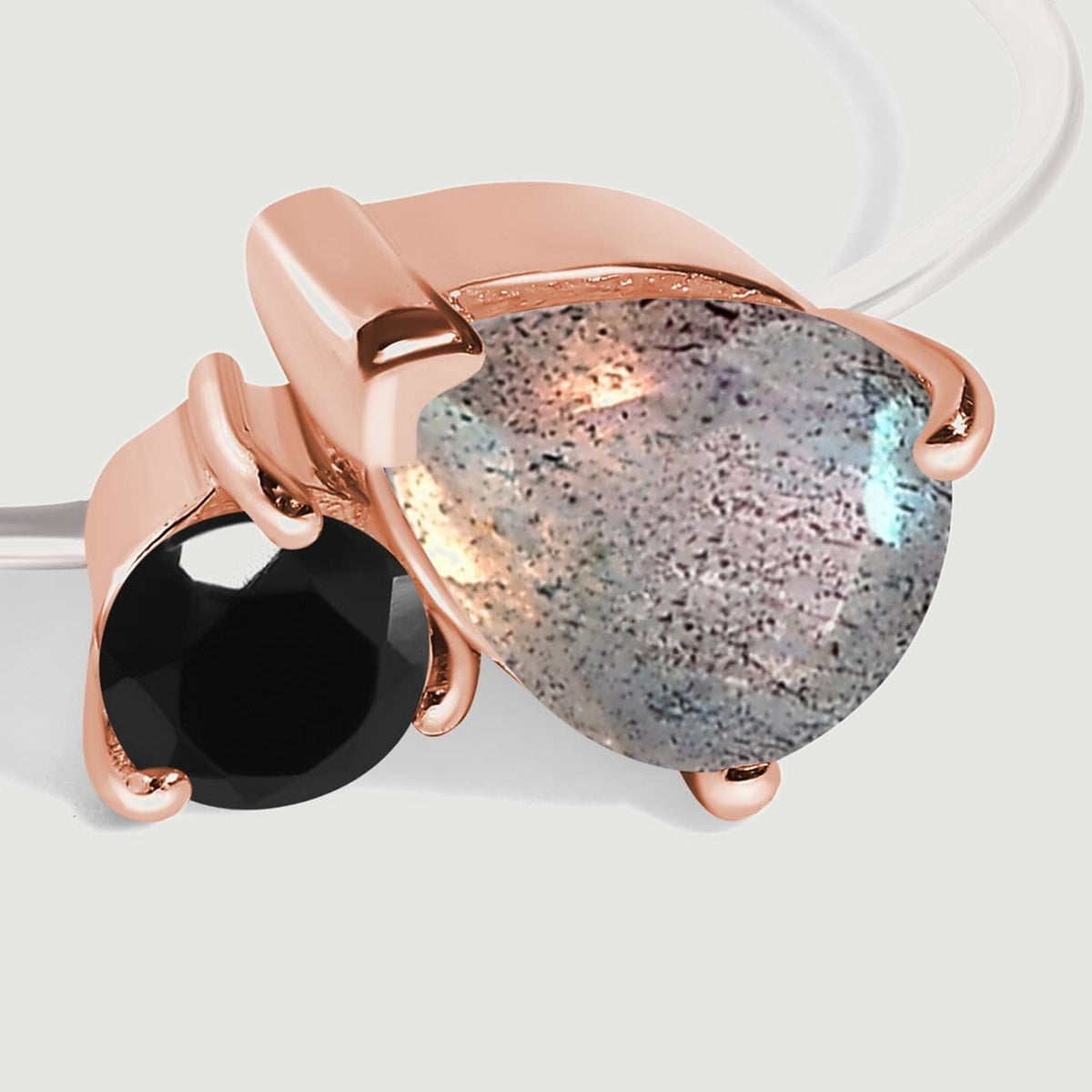 The grey pear-shaped labradorite and round black obsidian sit side by side in rose gold prong settings.