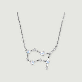 A silver necklace shows blue flashes in its round moonstones, linked by slender polished bars.