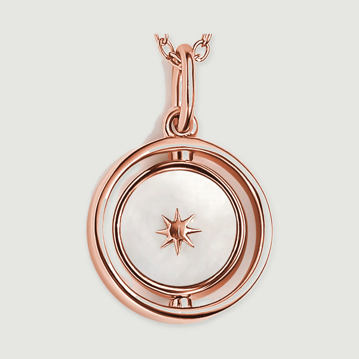 A macro view shows the rose gold star resting on a mother-of-pearl disc inside a smooth circular pendant.