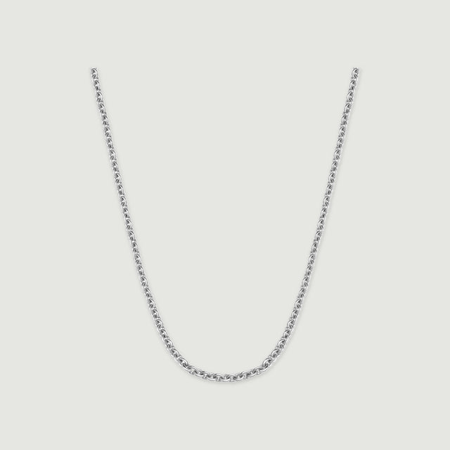A polished silver chain forms a U-shaped curve on a light gray background.