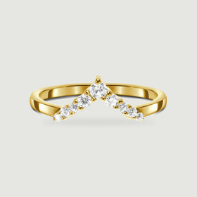 A yellow gold ring shows a pointed row of clear stones and a smooth curved shank.