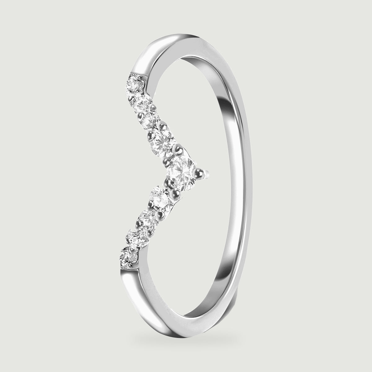An upright silver ring reveals the raised clear stones and the inside of its slim band.