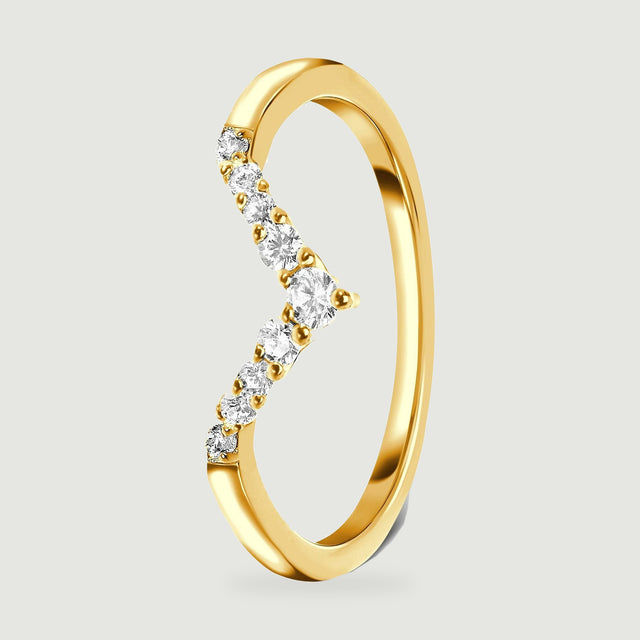 A yellow gold band stands at an angle with round clear stones along the pointed front.